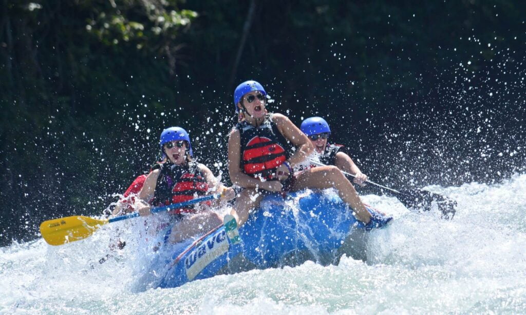 Thrill-seekers tackling the challenging rapids on the Sarapiquí River in Costa Rica."